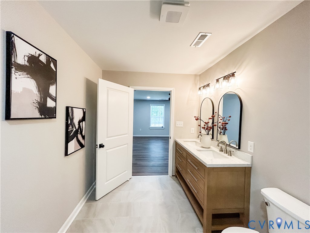 10295 Ashcake Road Ashland, VA 23005 - Photo 12 of 24 Dual vanity with light wood-finish cabinetry and w