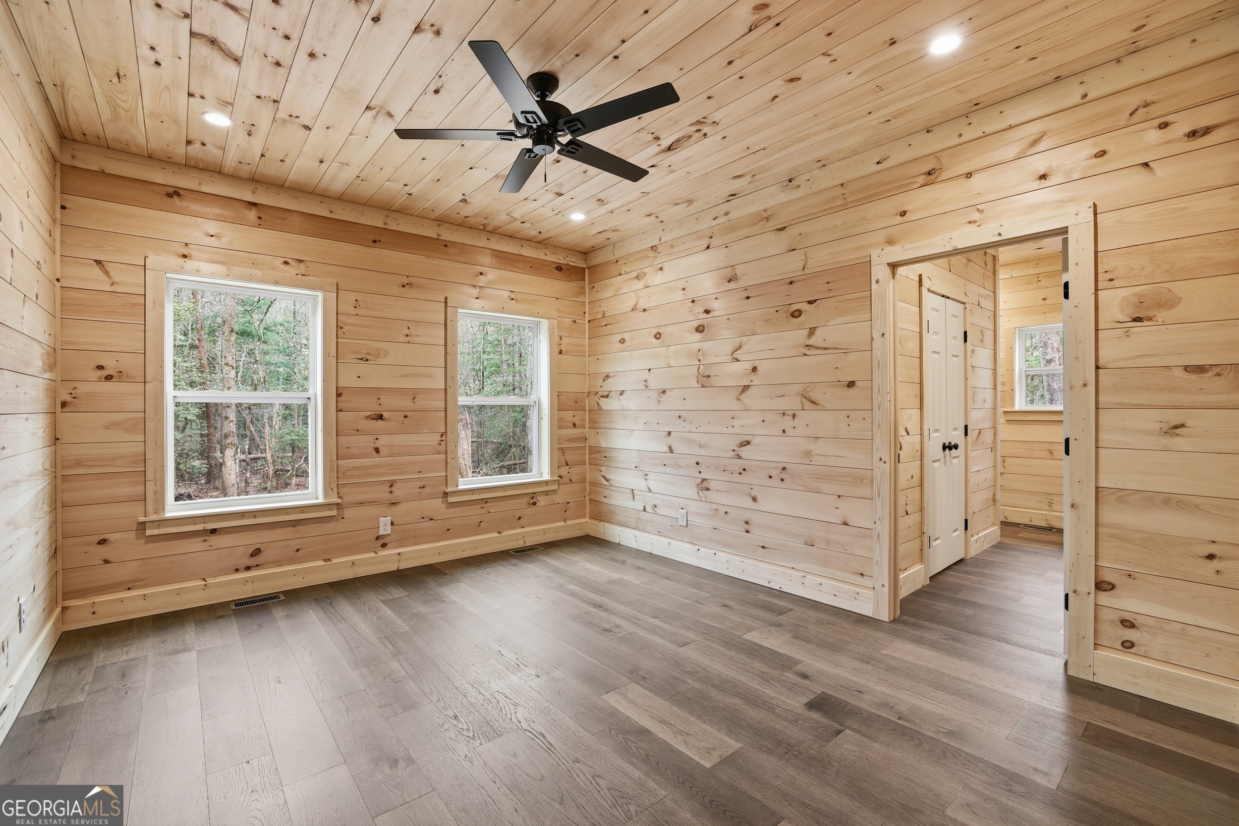 74 Blanche Place Road Clayton, GA 30525 - Photo 13 of 42 an empty room with wooden floor a ceiling fan and windows