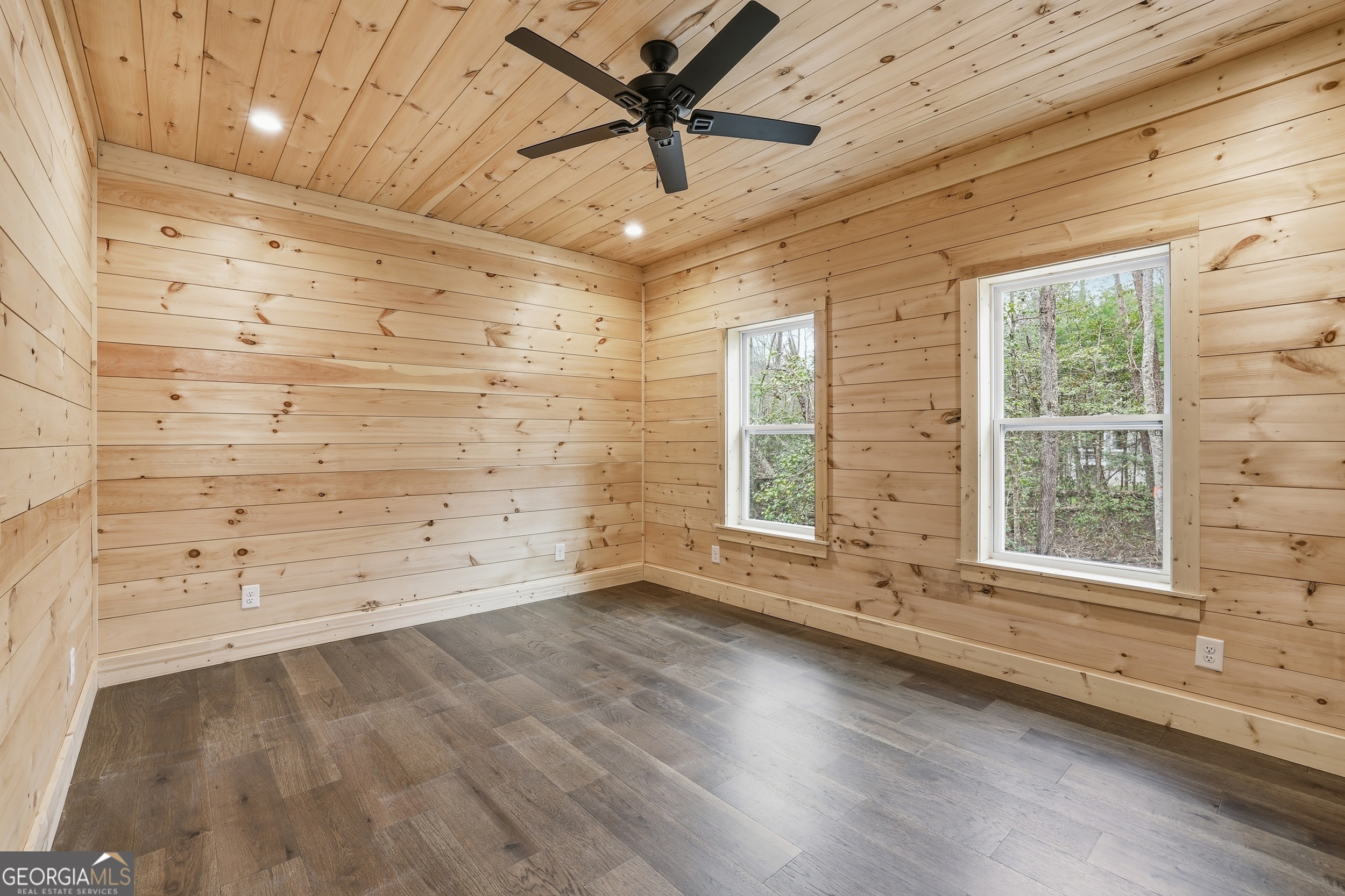 74 Blanche Place Road Clayton, GA 30525 - Photo 24 of 42 an empty room with wooden floor and windows with curtains