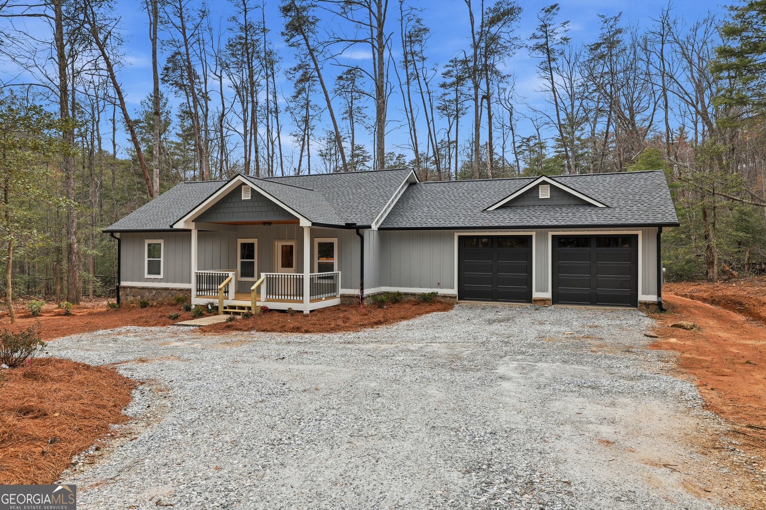74 Blanche Place Road Clayton, GA 30525 - Photo 3 of 42 a front view of a house with a garden and trees