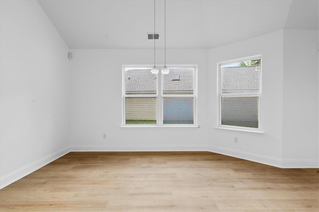 156 Cottage Club Drive Locust Grove, GA 30248 - Photo 14 of 34 a view of empty room with wooden floor and fan