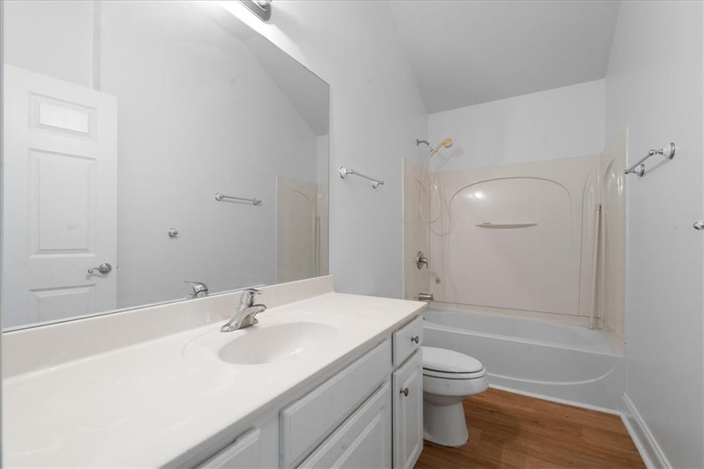 156 Cottage Club Drive Locust Grove, GA 30248 - Photo 16 of 34 a bathroom with a sink a toilet and shower