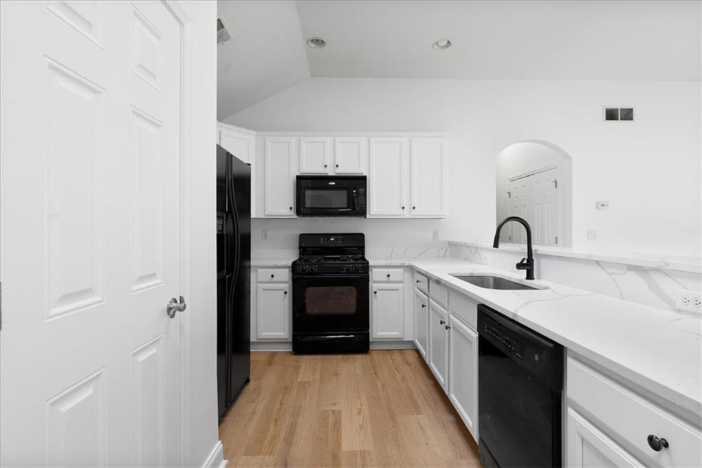 156 Cottage Club Drive Locust Grove, GA 30248 - Photo 4 of 34 a kitchen with a sink and a stove