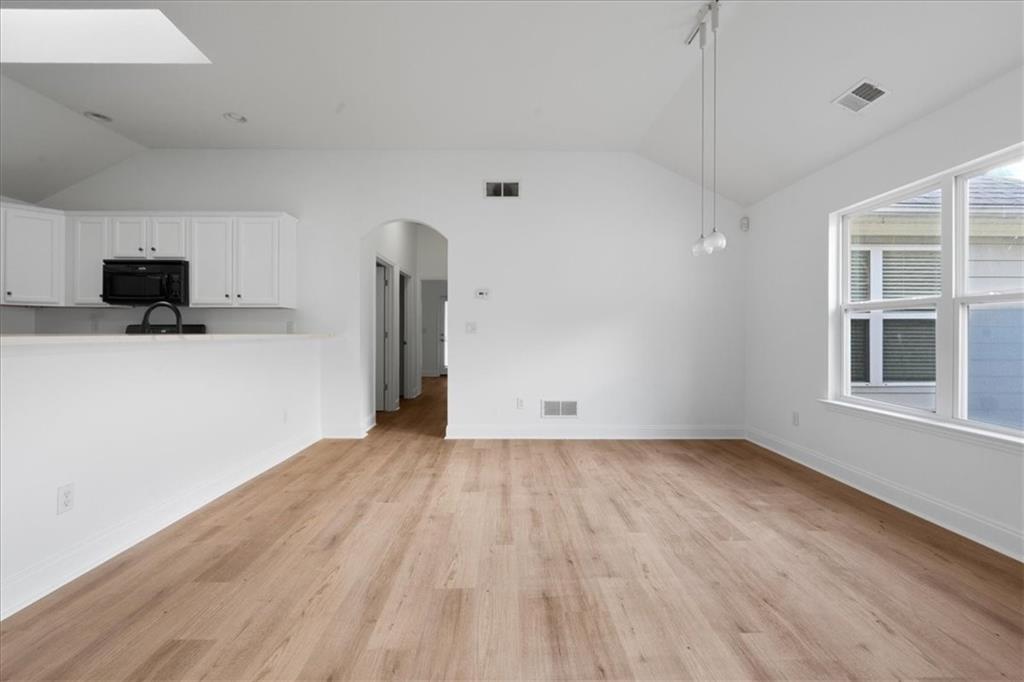 156 Cottage Club Drive Locust Grove, GA 30248 - Photo 6 of 34 a view of empty room with wooden floor and fan