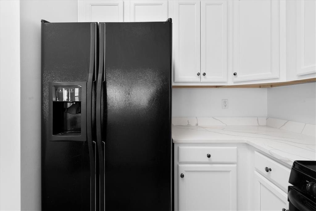 156 Cottage Club Drive Locust Grove, GA 30248 - Photo 7 of 34 a kitchen with a refrigerator and cabinets