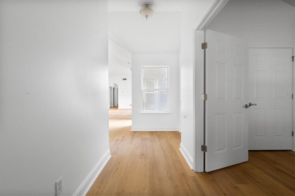 156 Cottage Club Drive Locust Grove, GA 30248 - Photo 8 of 34 a view of a hallway with wooden floor