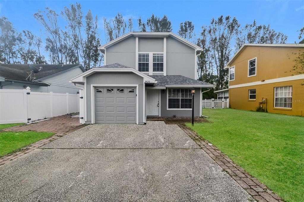 3420 Hamlet Loop Winter Park, FL 32792 - Photo 1 of 1 a front view of a house with a garden