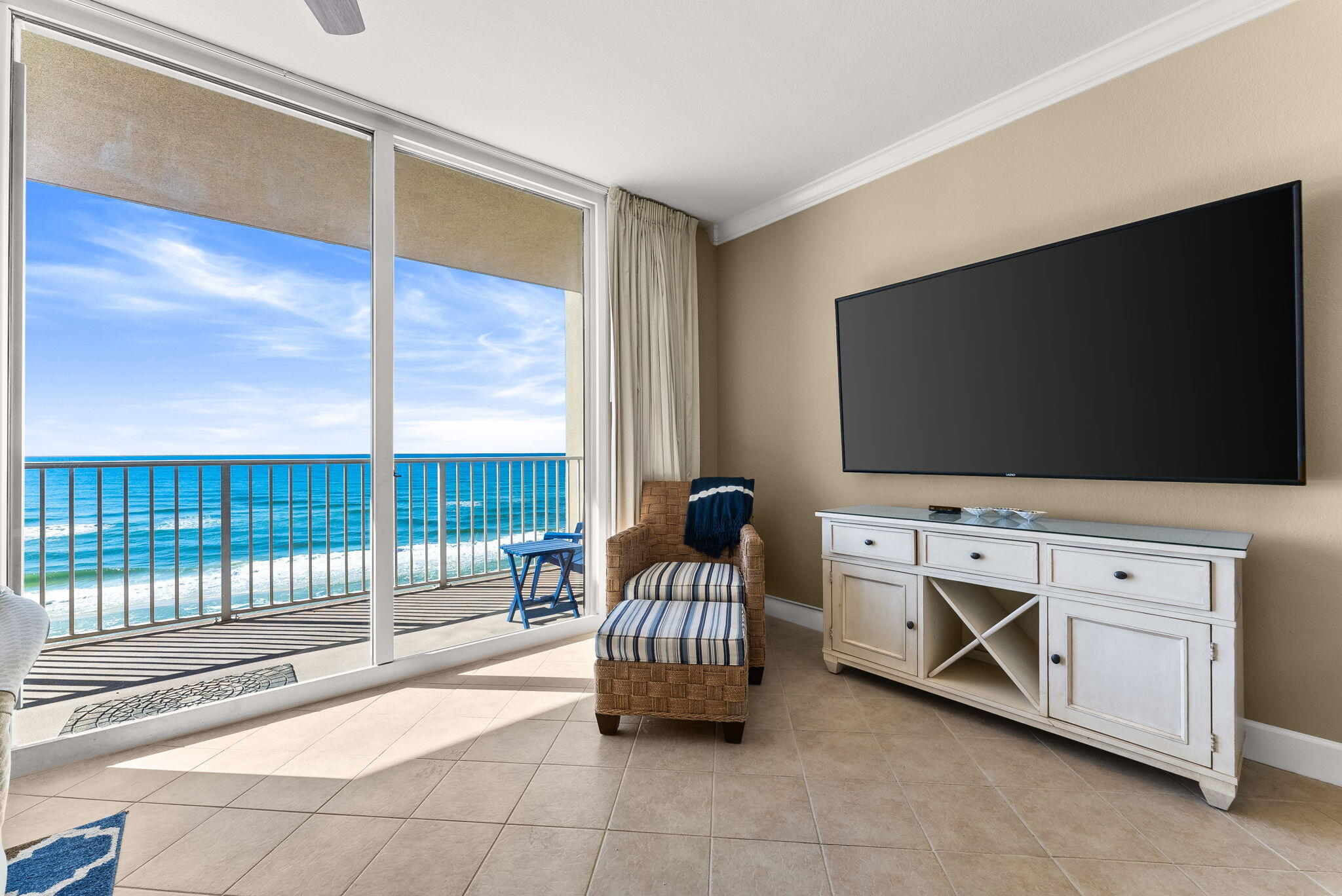 16819 Front Beach Road, Unit 411 Panama City Beach, FL 32413 - Photo 19 of 44 a living room with furniture and a flat screen tv