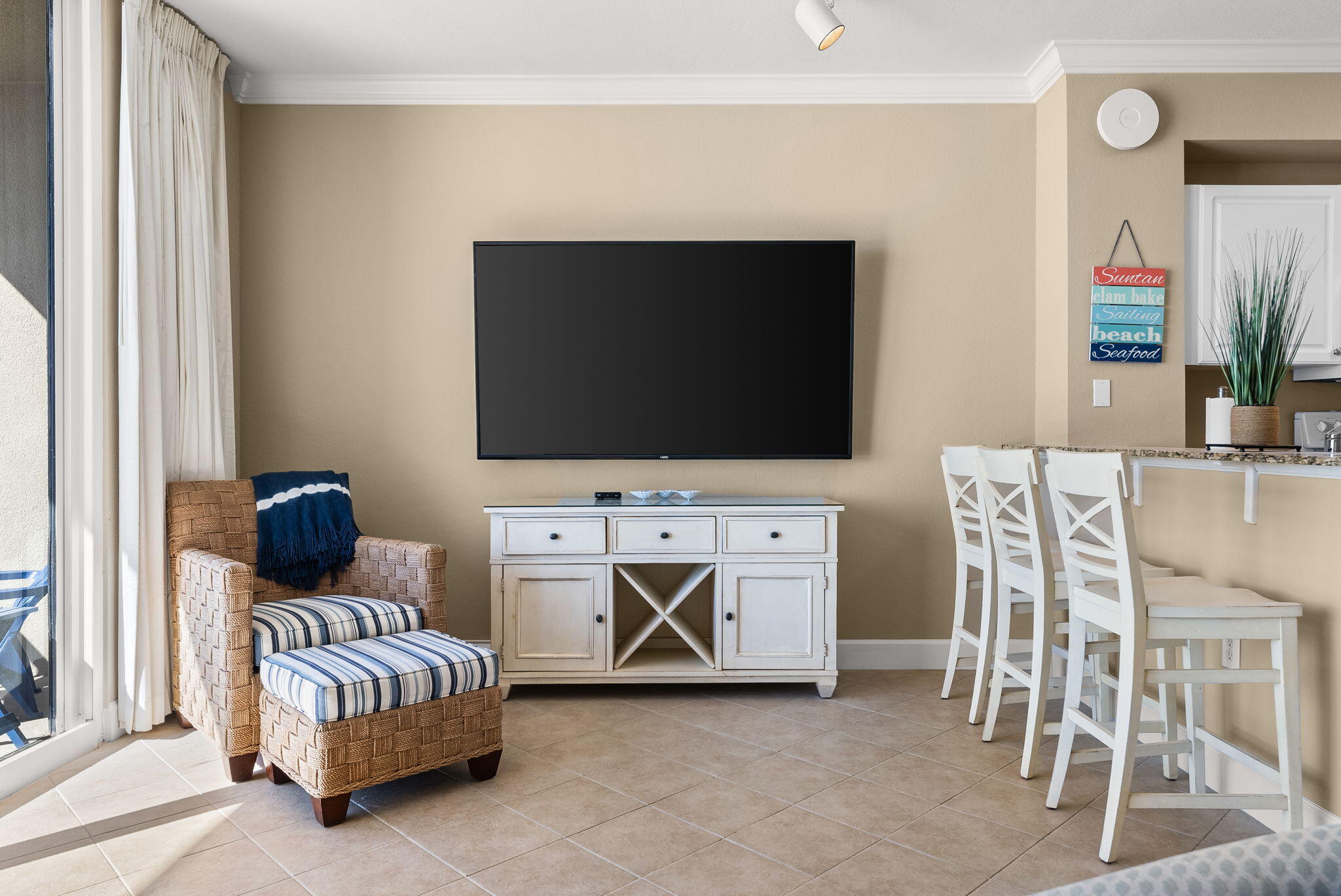 16819 Front Beach Road, Unit 411 Panama City Beach, FL 32413 - Photo 20 of 44 a living room with furniture and a flat screen tv