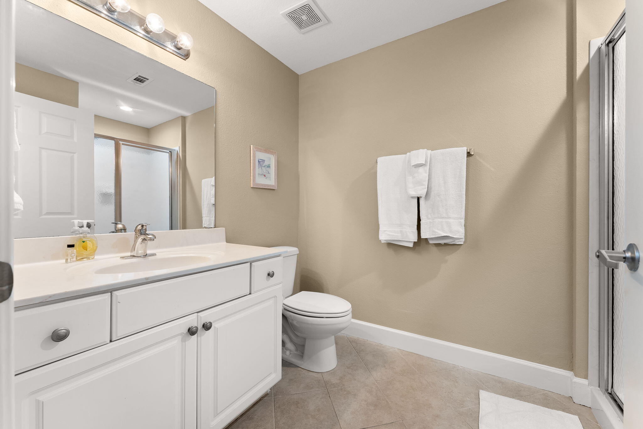 16819 Front Beach Road, Unit 411 Panama City Beach, FL 32413 - Photo 23 of 44 a bathroom with a toilet sink and mirror