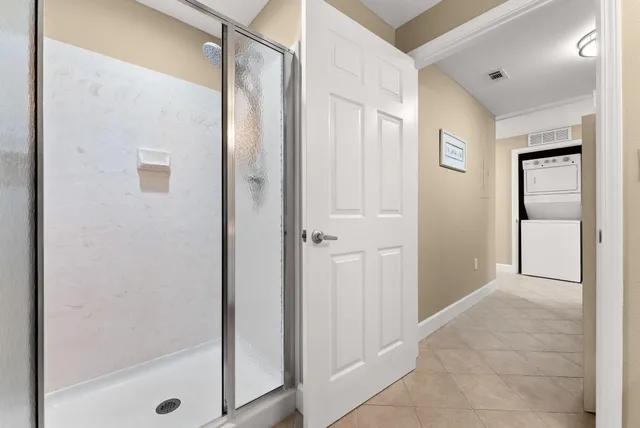 a bathroom with a shower and a glass door