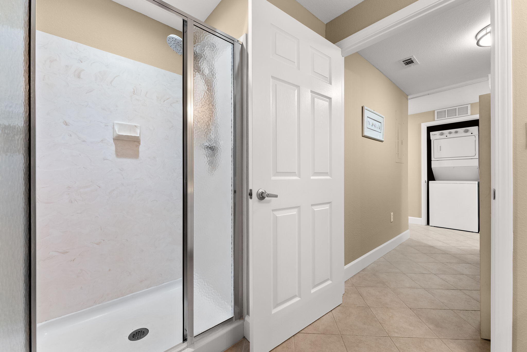 16819 Front Beach Road, Unit 411 Panama City Beach, FL 32413 - Photo 24 of 44 a bathroom with a shower and a glass door