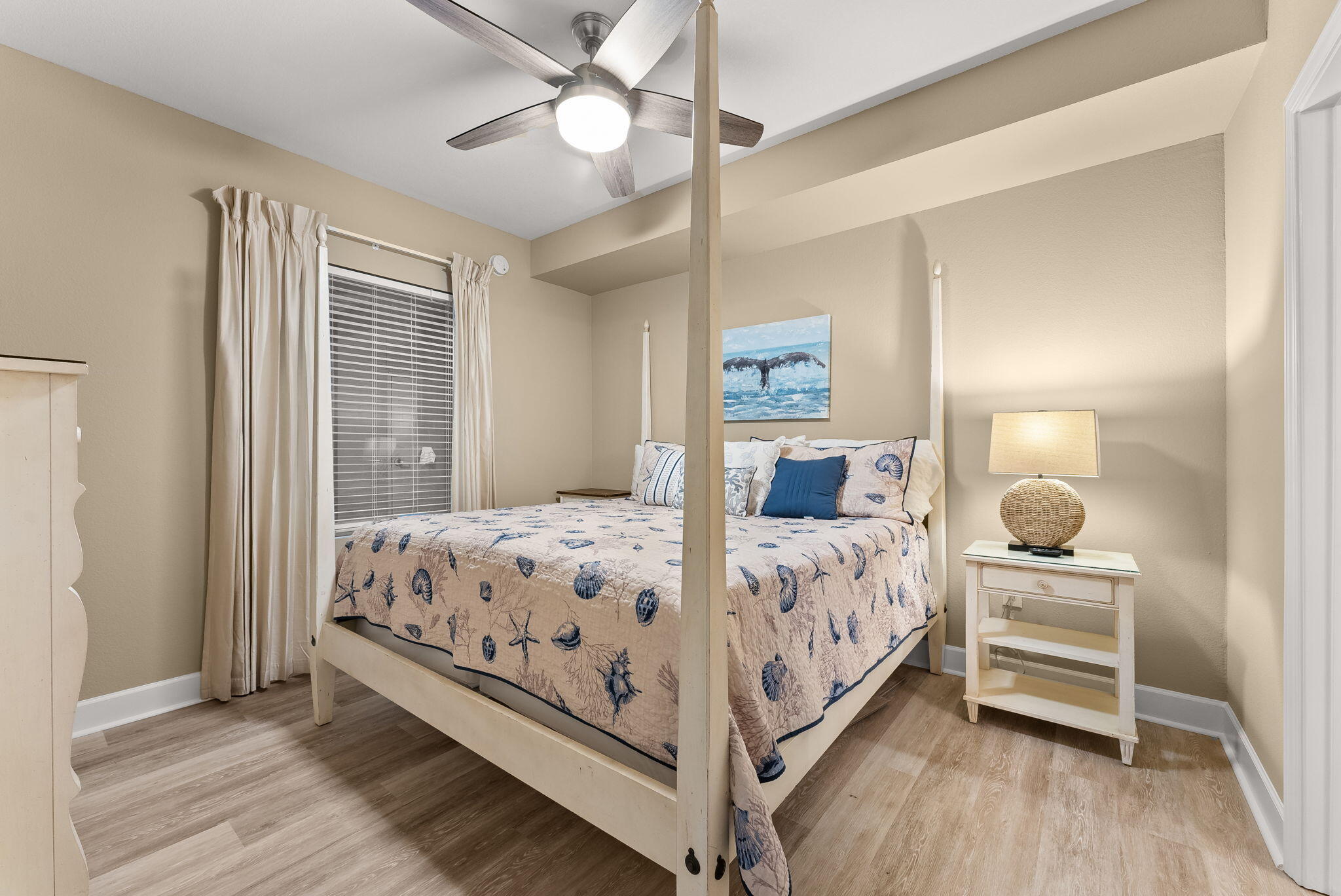 16819 Front Beach Road, Unit 411 Panama City Beach, FL 32413 - Photo 25 of 44 a bedroom with a bed and a chandelier