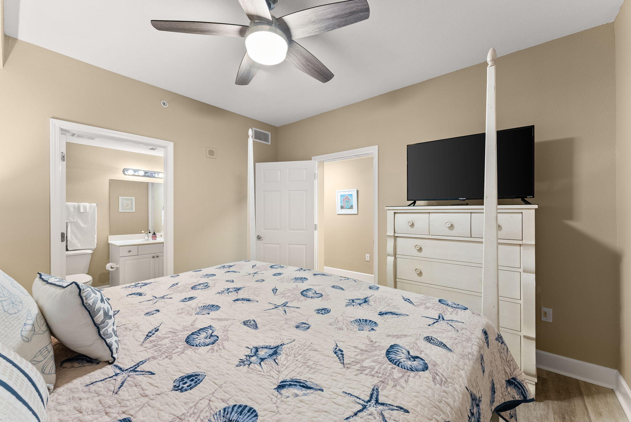 16819 Front Beach Road, Unit 411 Panama City Beach, FL 32413 - Photo 26 of 44 a bedroom with a bed and a flat screen tv
