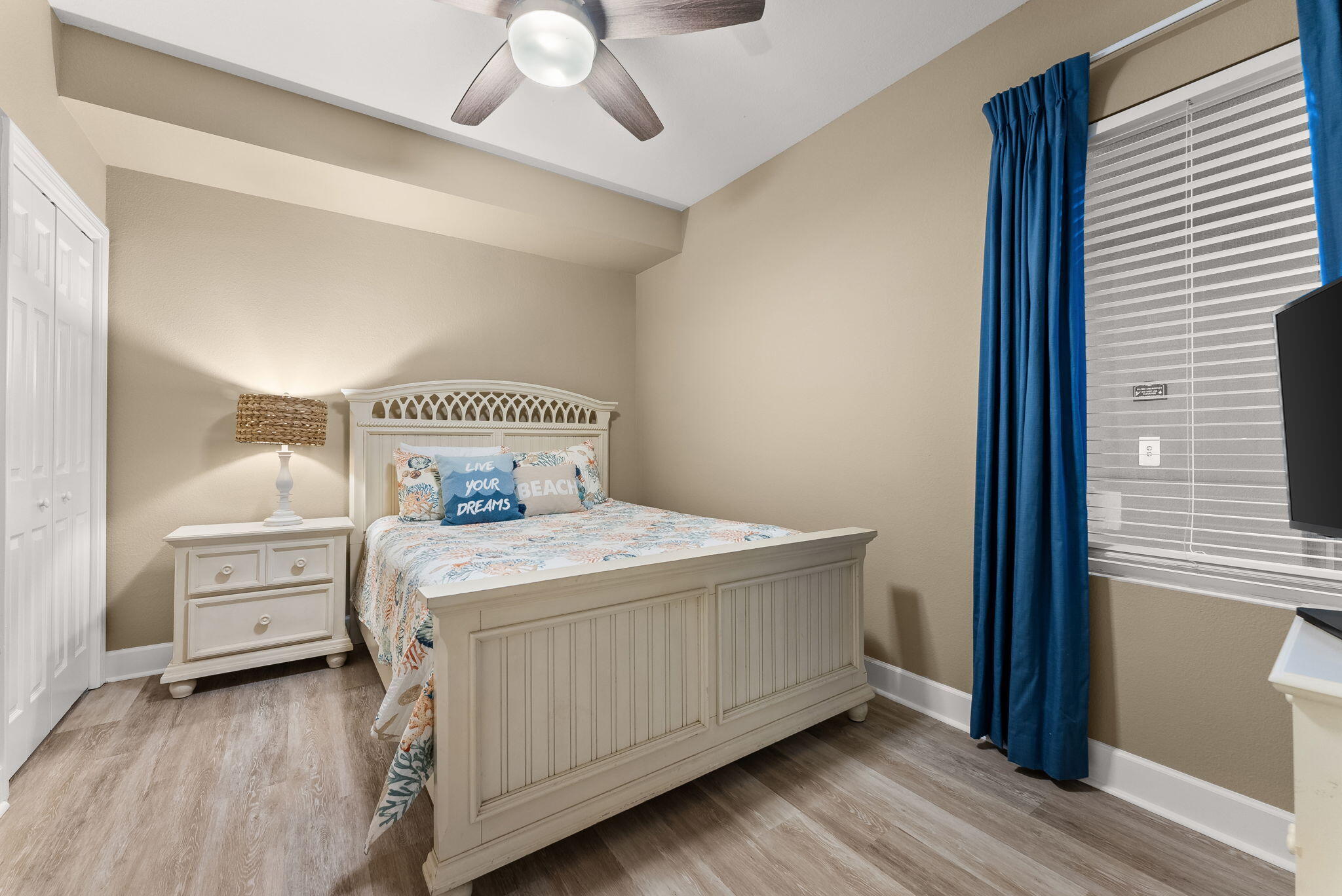 16819 Front Beach Road, Unit 411 Panama City Beach, FL 32413 - Photo 28 of 44 a bedroom with a bed and wooden floor