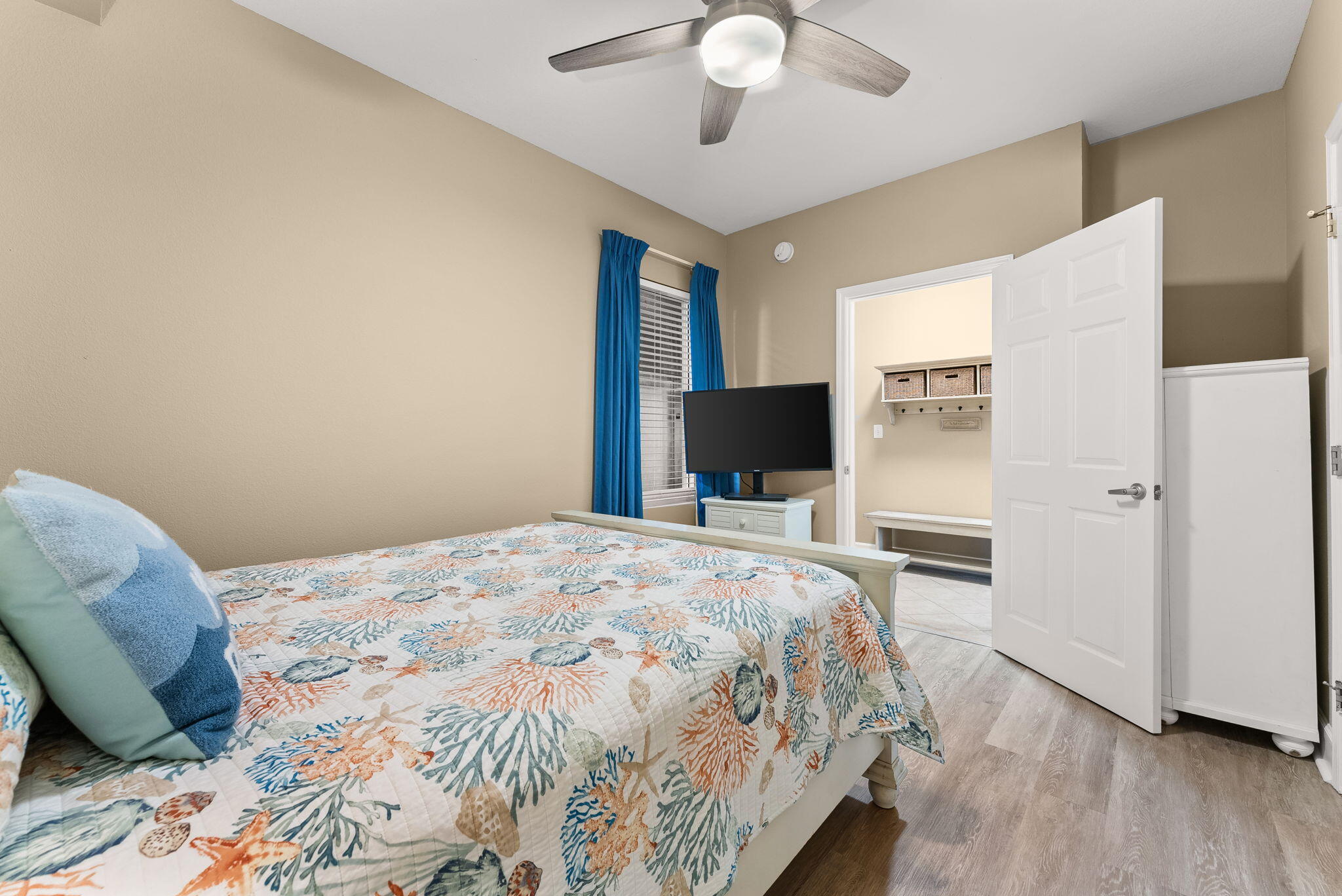16819 Front Beach Road, Unit 411 Panama City Beach, FL 32413 - Photo 29 of 44 a bedroom with a bed and a chandelier