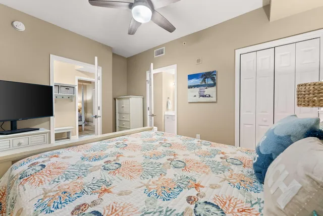 a bedroom with a bed and a flat screen tv