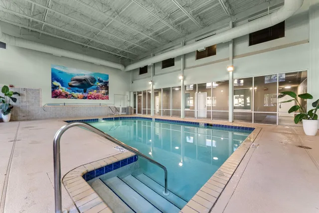 a view of a swimming pool with a lawn chairs