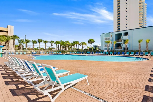 a view of swimming pool with outdoor seating and city view