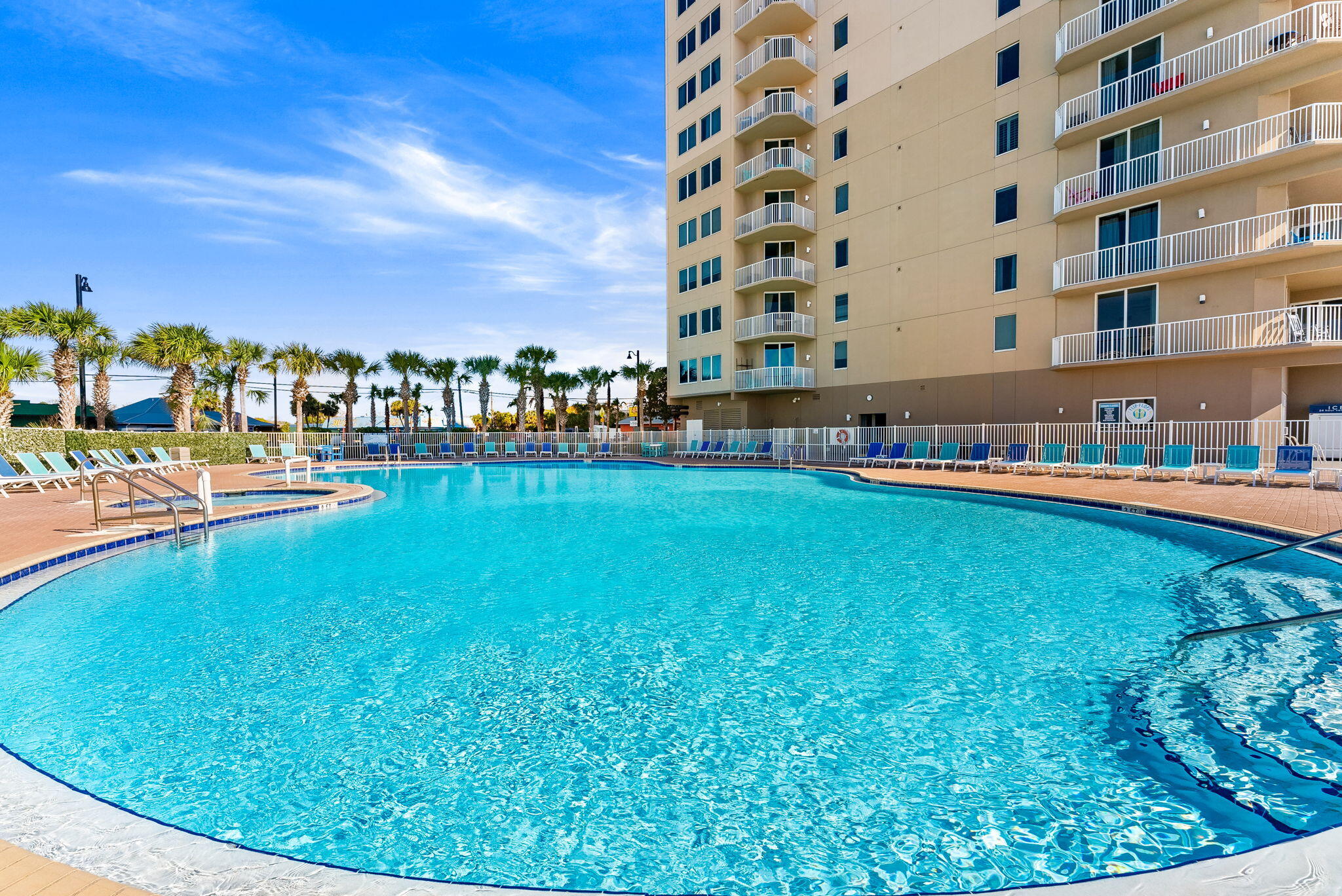 16819 Front Beach Road, Unit 411 Panama City Beach, FL 32413 - Photo 42 of 44 a multi story building with trees in the background