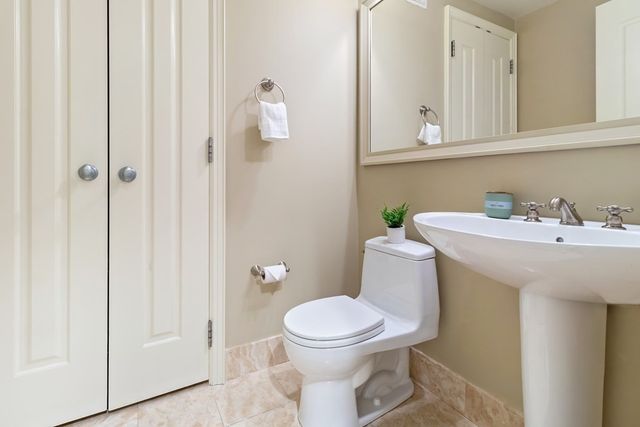 a bathroom with a sink a toilet and mirror
