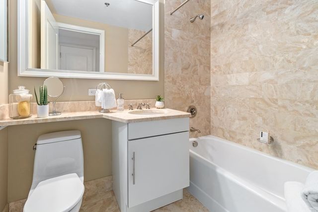 a bathroom with a sink a toilet and bathtub