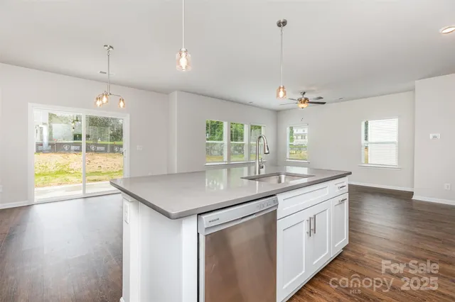 a kitchen with center island table and chairs