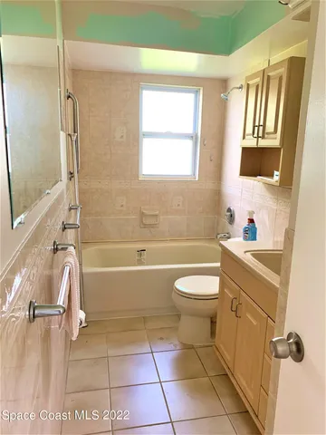 a bathroom with a granite countertop sink a toilet and a bathtub