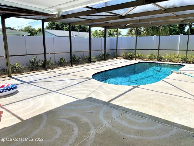 a swimming pool with an outdoor seating and yard