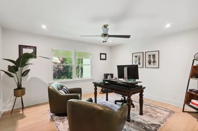 a view of kitchen with stainless steel appliances dining table and chairs