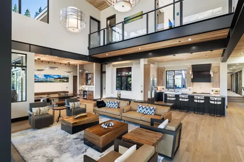 a living room with furniture kitchen view and a large window