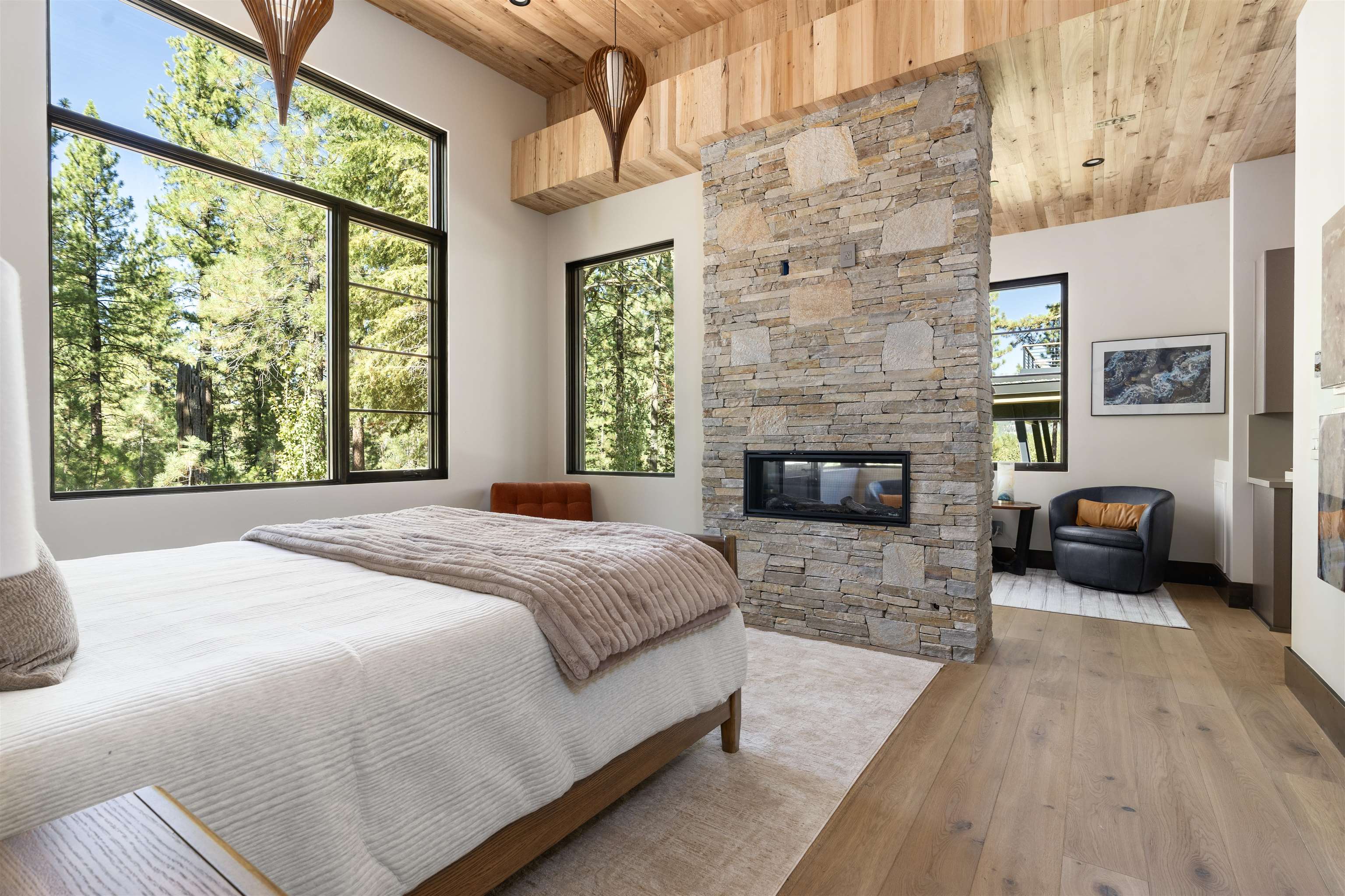130 James Reed Truckee, CA 96161 - Photo 15 of 28 a spacious bedroom with a bed and a fireplace