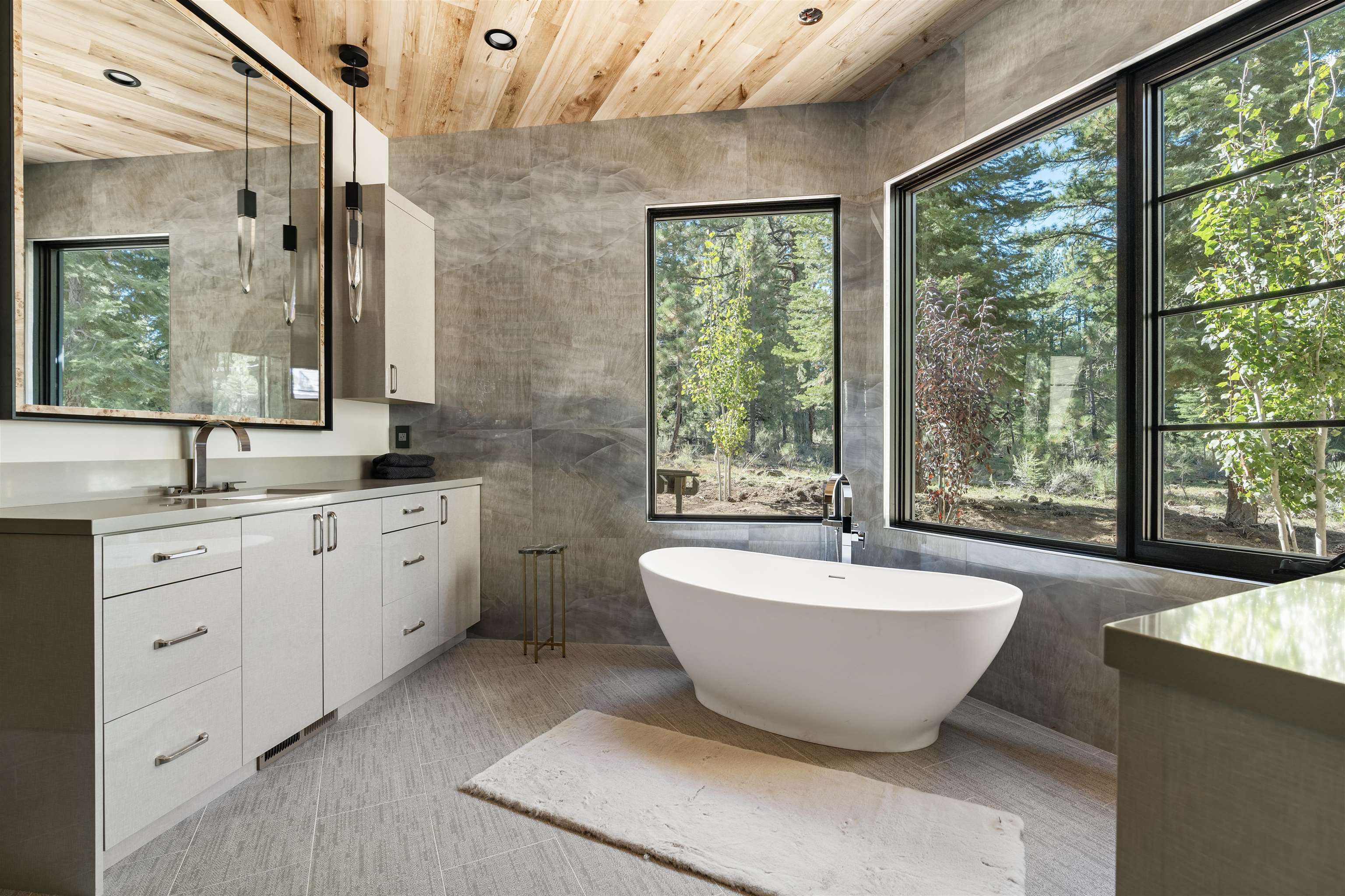 130 James Reed Truckee, CA 96161 - Photo 16 of 28 a spacious bathroom with a double vanity sink large mirror bathtub and window