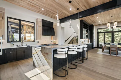 a view of kitchen with sink dining table and chairs