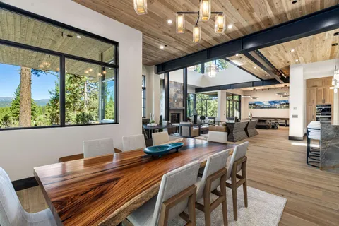 a dining room with furniture a rug and wooden floor