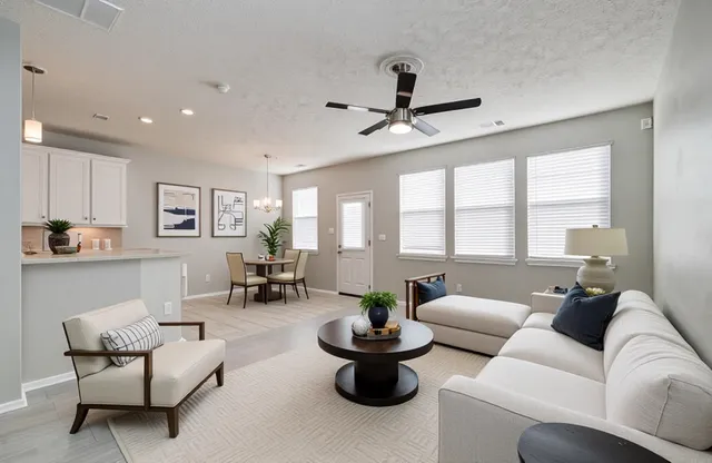 a view of a livingroom with a ceiling fan and window