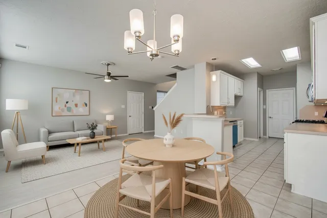 an empty room with a window and a ceiling fan