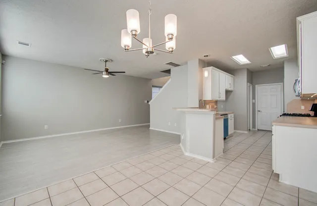 a view of an empty room with a ceiling fan