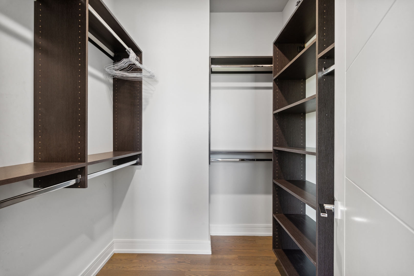 2352 West Winona Street, Unit 2W Chicago, IL 60625 - Photo 13 of 22 a view of walk in closet with empty racks