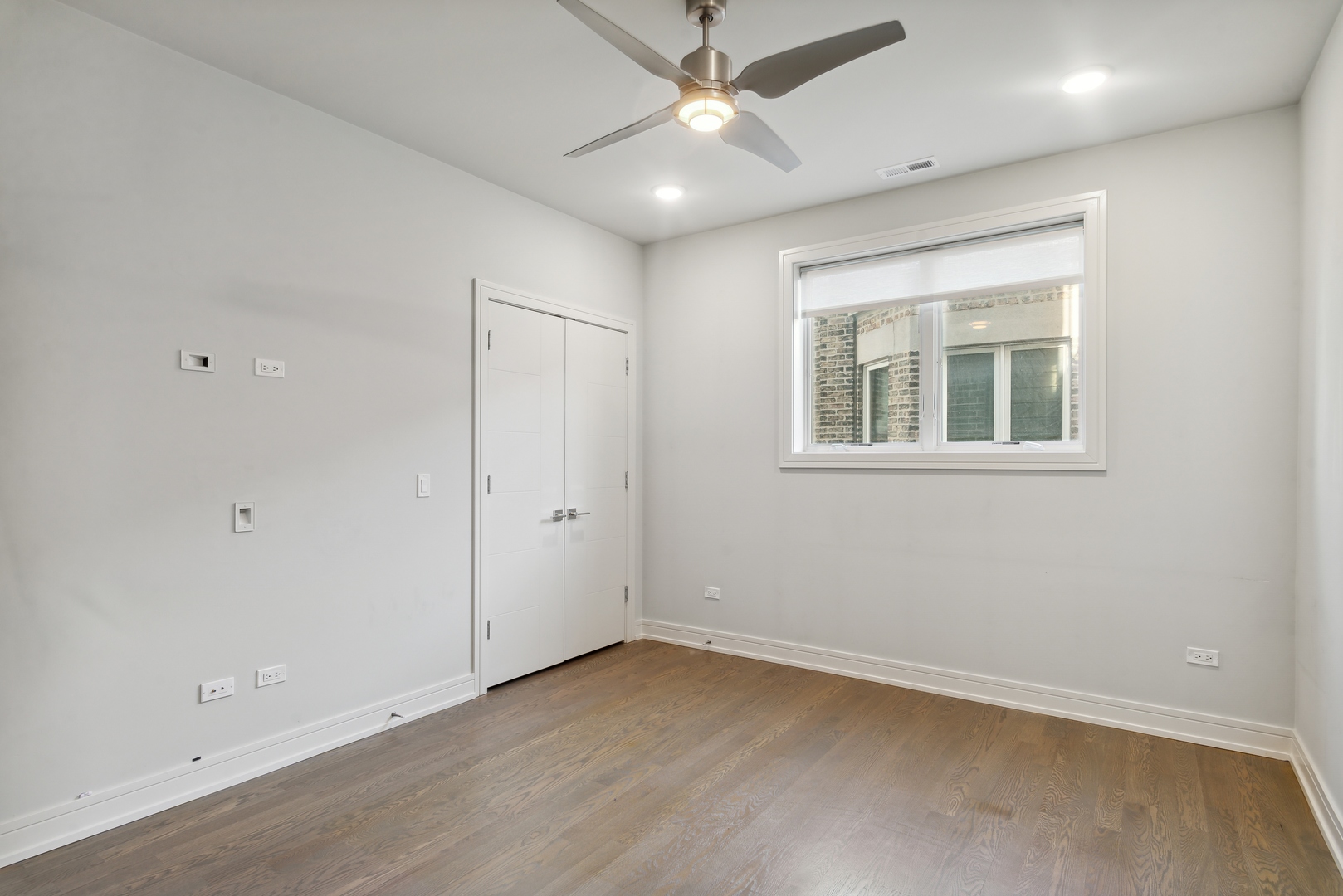 2352 West Winona Street, Unit 2W Chicago, IL 60625 - Photo 19 of 22 an empty room with a ceiling fan and a window