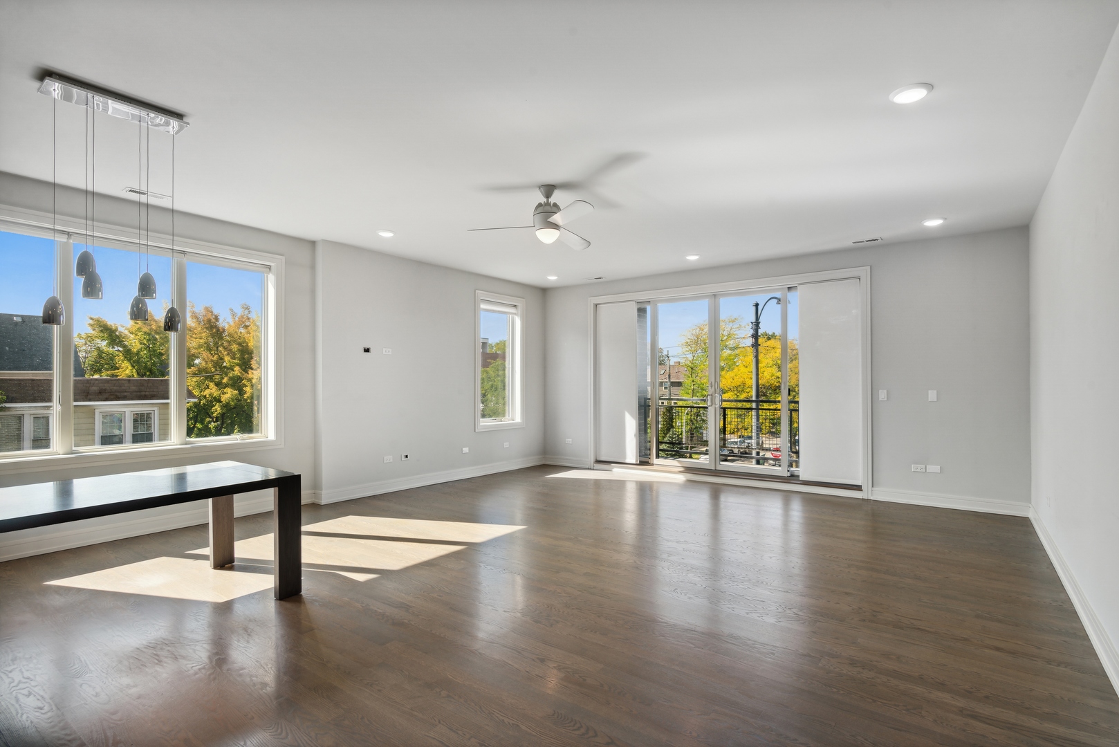 2352 West Winona Street, Unit 2W Chicago, IL 60625 - Photo 3 of 22 a view of an empty room with a window and wooden floor