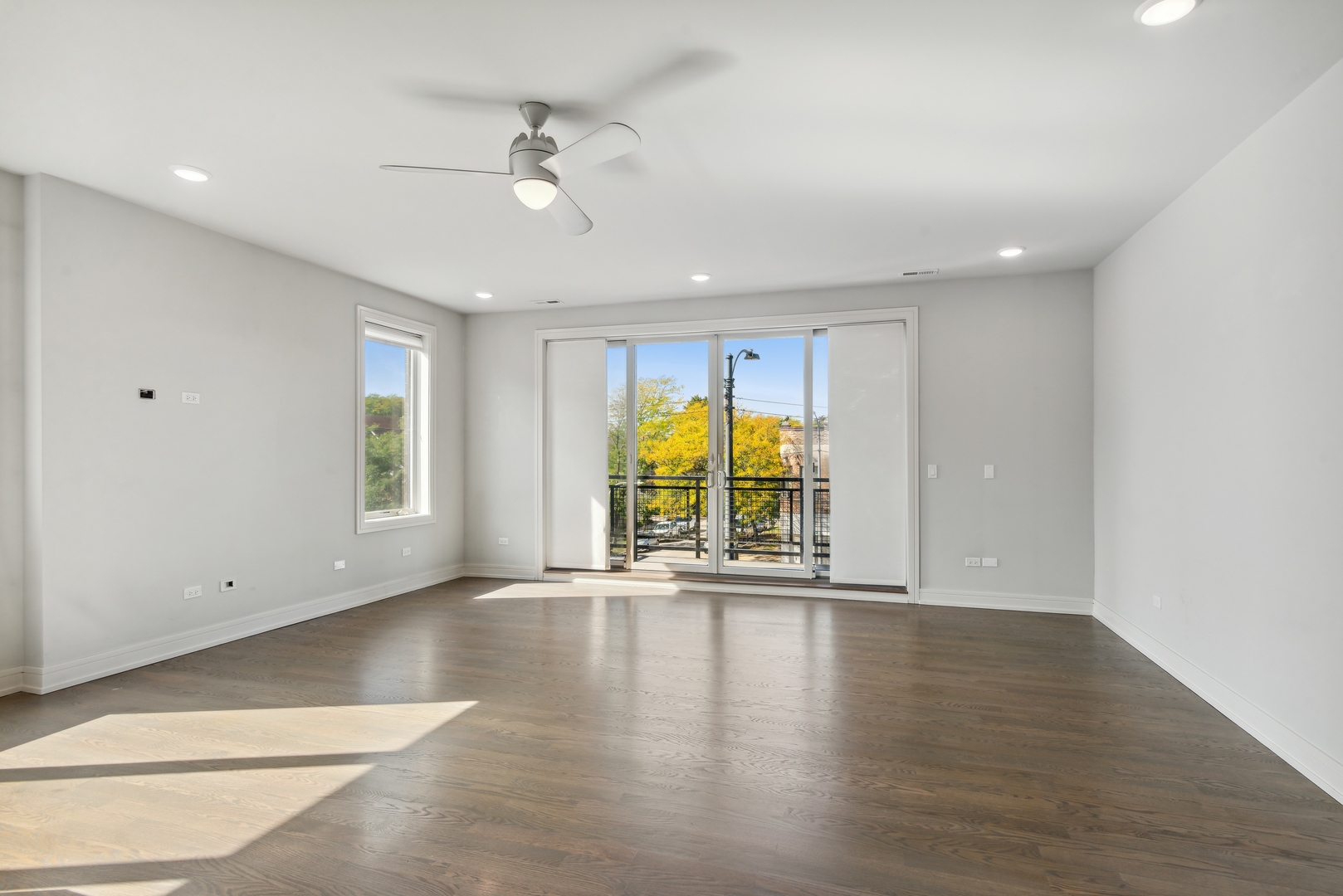 2352 West Winona Street, Unit 2W Chicago, IL 60625 - Photo 5 of 22 a view of an empty room with a window and wooden floor