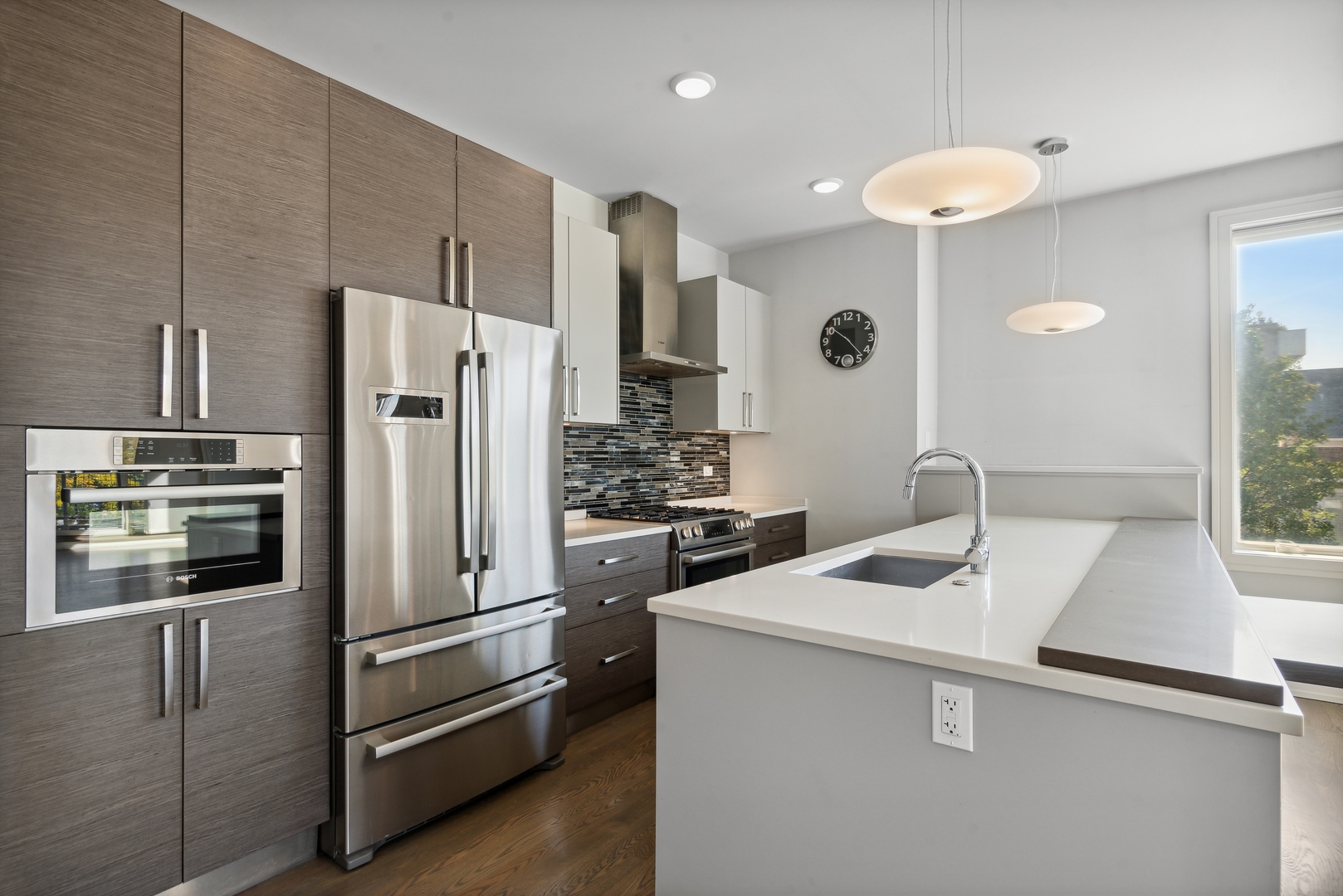 2352 West Winona Street, Unit 2W Chicago, IL 60625 - Photo 8 of 22 a kitchen with a sink stainless steel appliances and cabinets