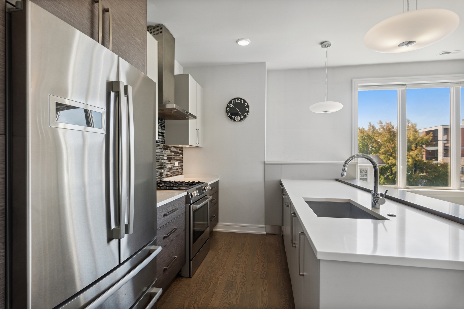 2352 West Winona Street, Unit 2W Chicago, IL 60625 - Photo 9 of 22 a kitchen with stainless steel appliances granite countertop a refrigerator and a sink