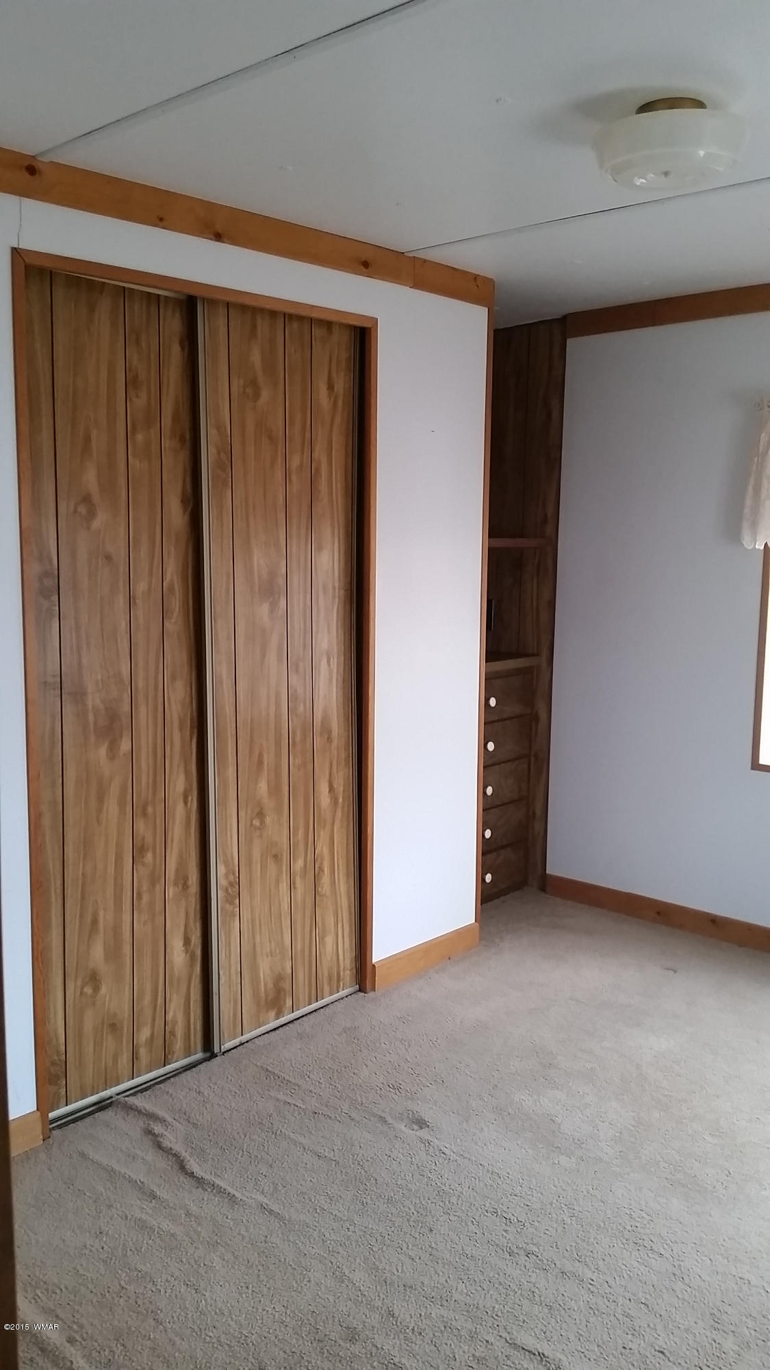 31 Alpine Lane Concho, AZ 85924 - Photo 1 of 16 a view of an empty room with wooden walls