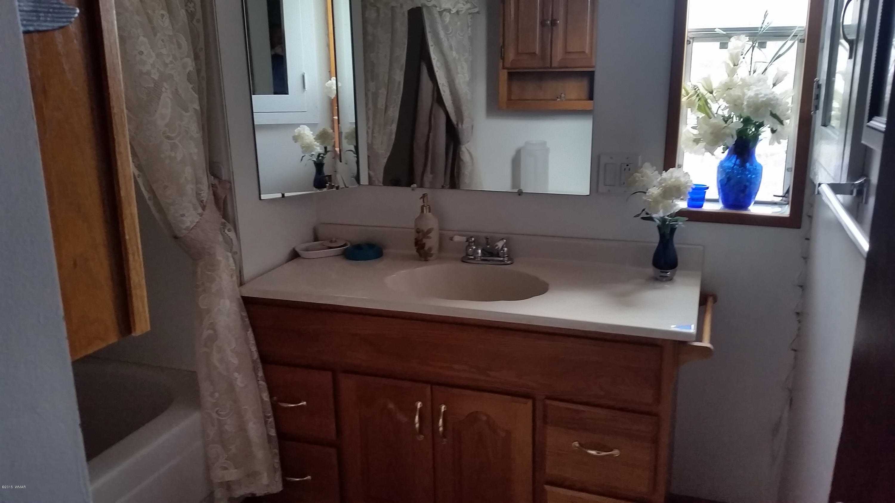 31 Alpine Lane Concho, AZ 85924 - Photo 13 of 16 a bathroom with a sink and a mirror