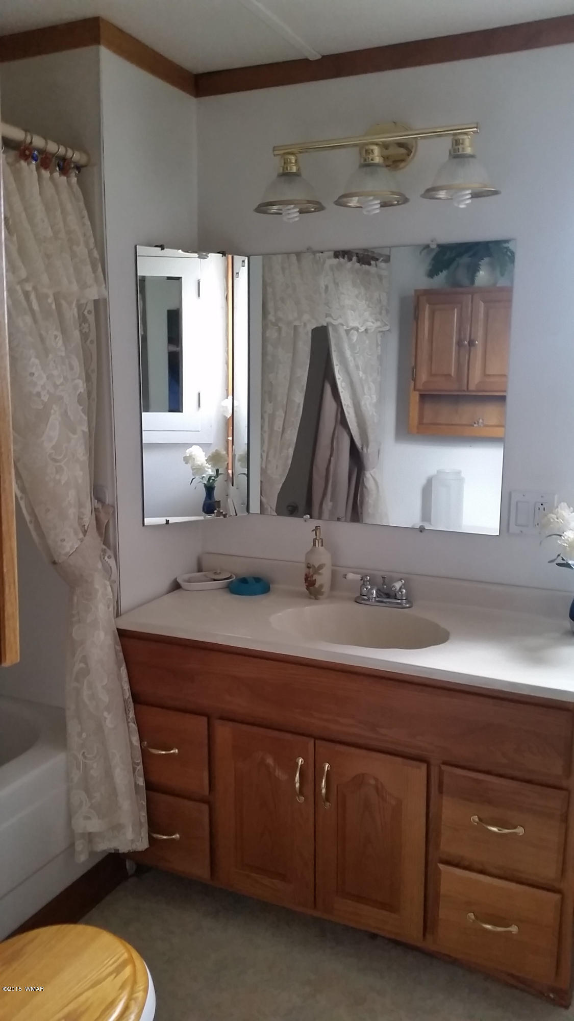 31 Alpine Lane Concho, AZ 85924 - Photo 5 of 16 a bathroom with a double vanity sink and a mirror
