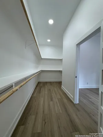 a view of a room with wooden floor
