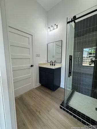 a room with a mirror and a shower