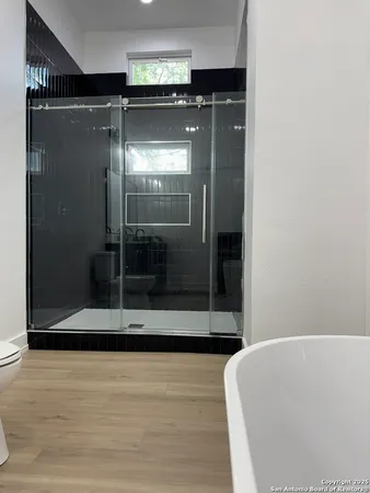 a bathroom with a glass shower door